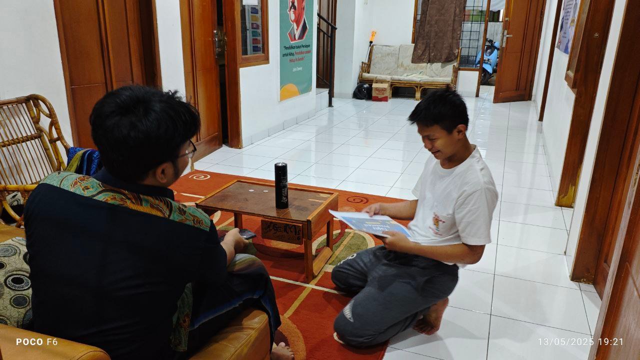 A person kneeling on the floor looking at a paper AI-generated content may be incorrect.