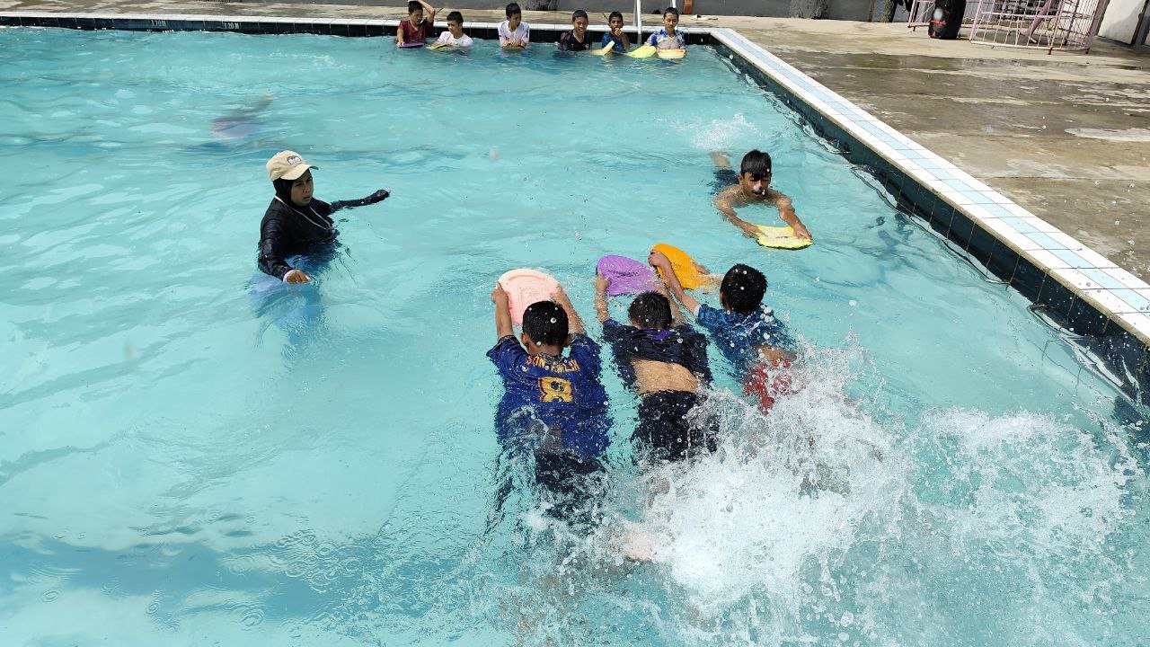 A group of people swimming in a pool AI-generated content may be incorrect.