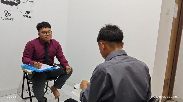 A person sitting in a chair and talking to another person AI-generated content may be incorrect.
