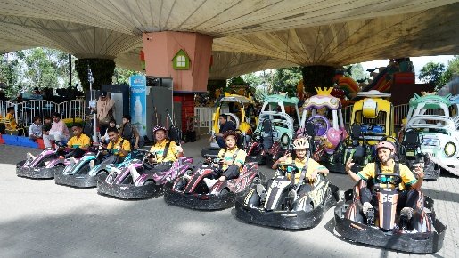 A group of people in go karts AI-generated content may be incorrect.