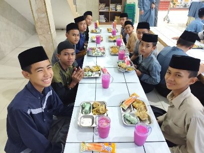 A group of boys sitting at a table with food and drinks

AI-generated content may be incorrect.