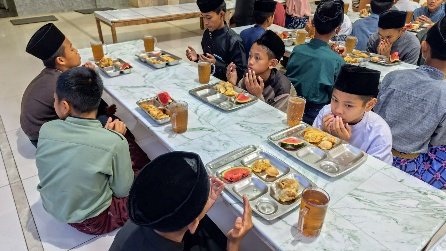 A group of people eating food at a table
AI-generated content may be incorrect.