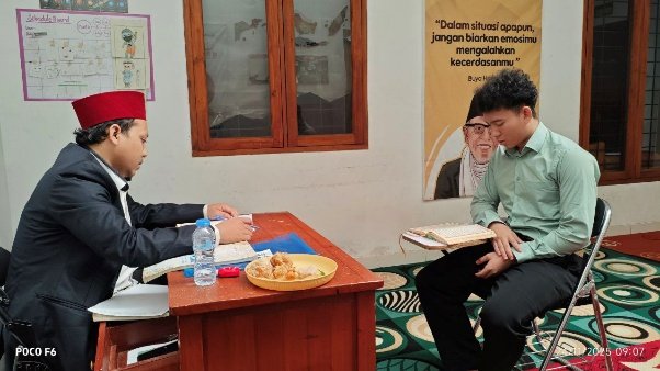 A person sitting at a desk with a book
AI-generated content may be incorrect.