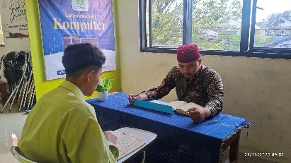 A person sitting at a table with a book

AI-generated content may be incorrect.